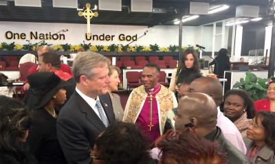 Governor-elect Charlie Baker and his wife Lauren receive a blessing from Archbishop A. Livingston Foxworth at a Grace Church of All Nations service on Sunday morning. 	Photo by Lauren Dezenski